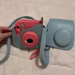 light pink Instax mini 9 poloroid camera with light blue crossbody cade included